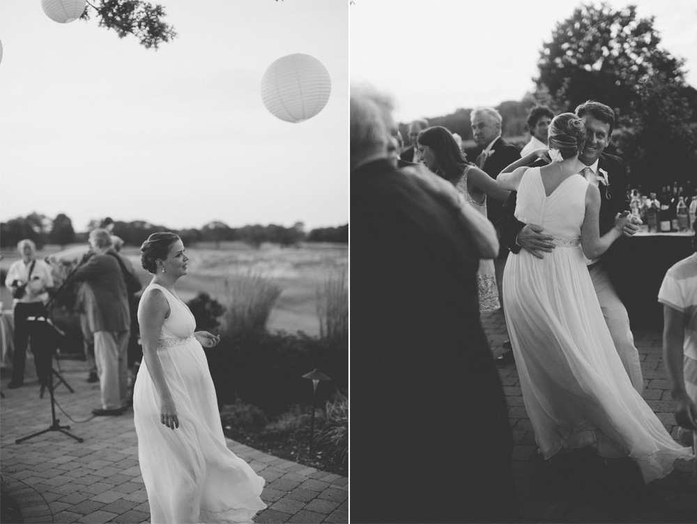 candid wedding photography in black and white of outdoor dancing at dusk