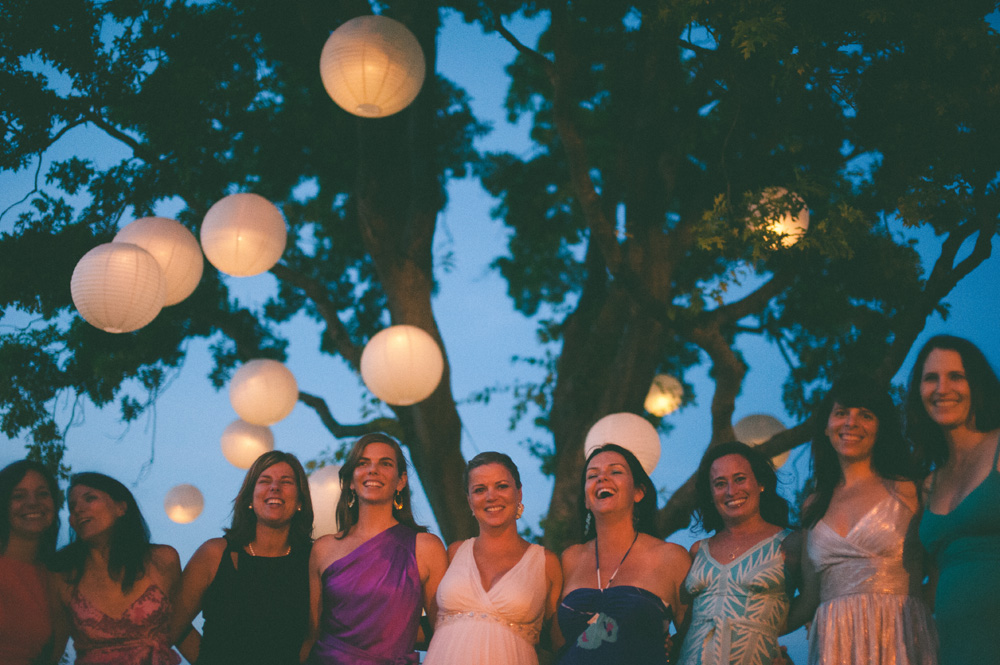 outdoor wedding reception paper lanterns lit up at night with group portrait