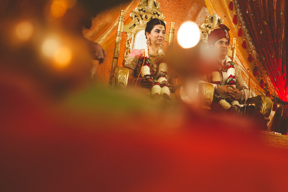 indian wedding photographer captures creatively the bride and groom during ceremony
