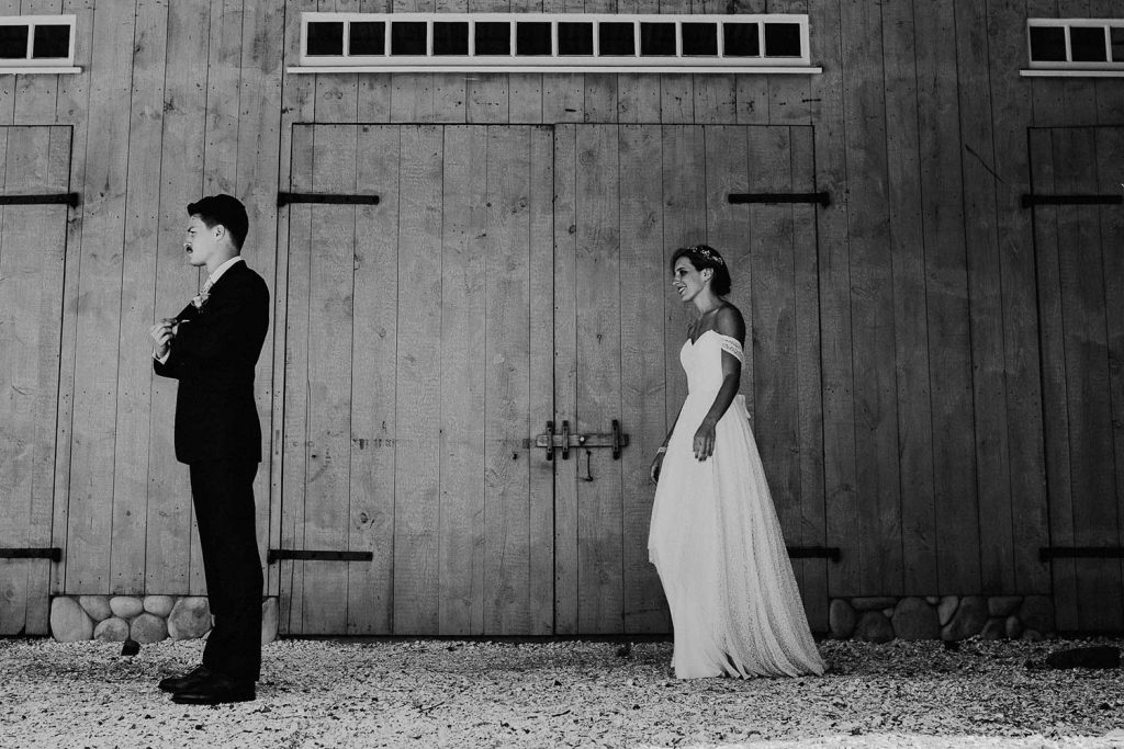 first look in front of barn at bonnet island wedding