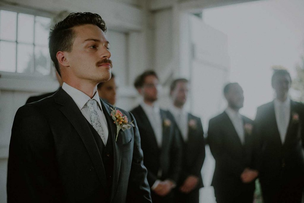 groom awaits bride during ceremony at bonnet island