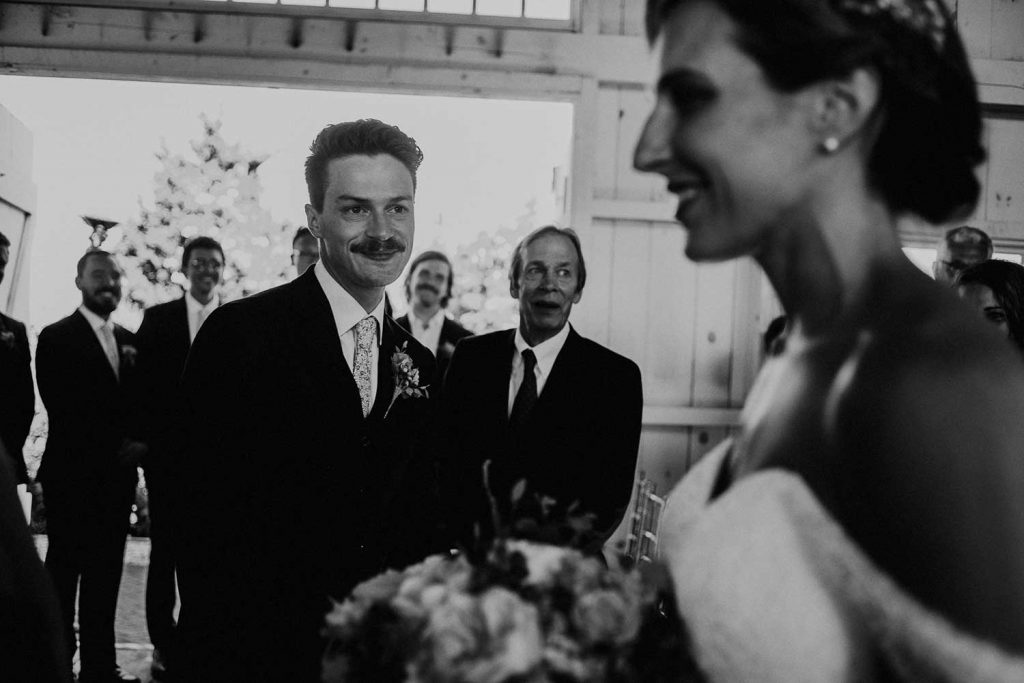 groom sees bride enter wedding ceremony at bonnet island chapel