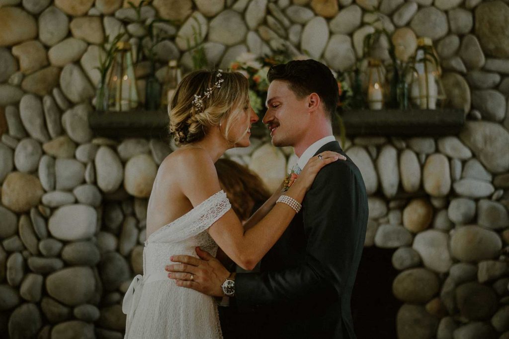 bride and groom kiss after wedding ceremony