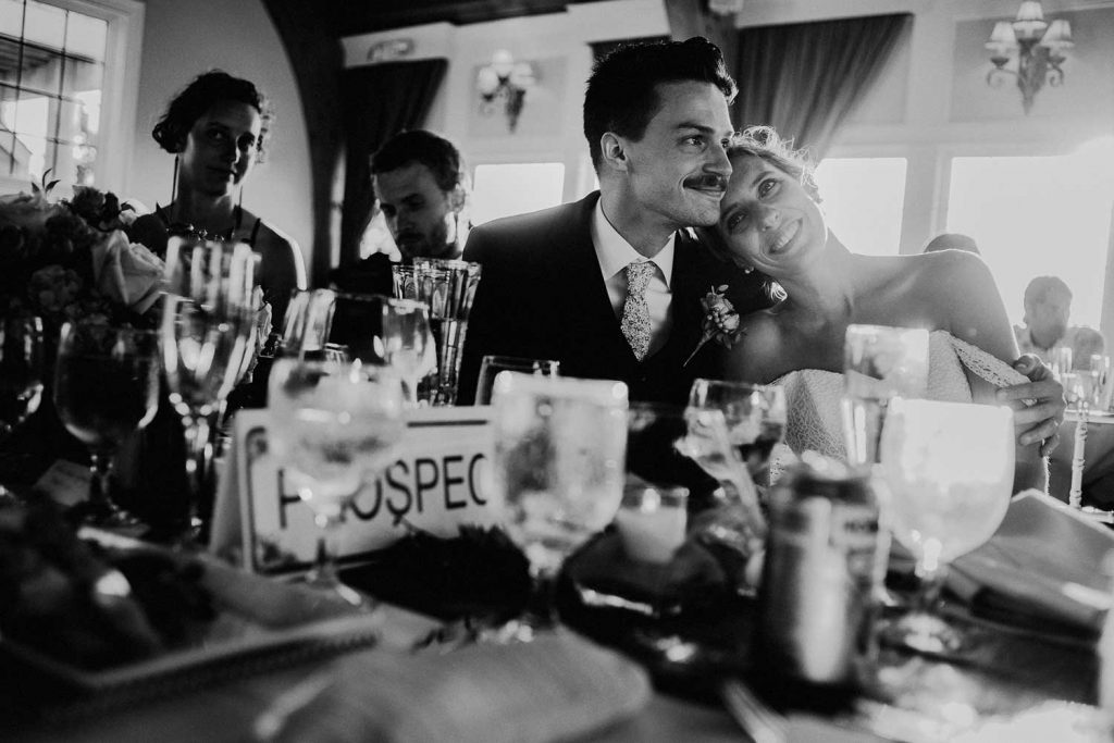 tender candid moment between bride and groom during their wedding reception