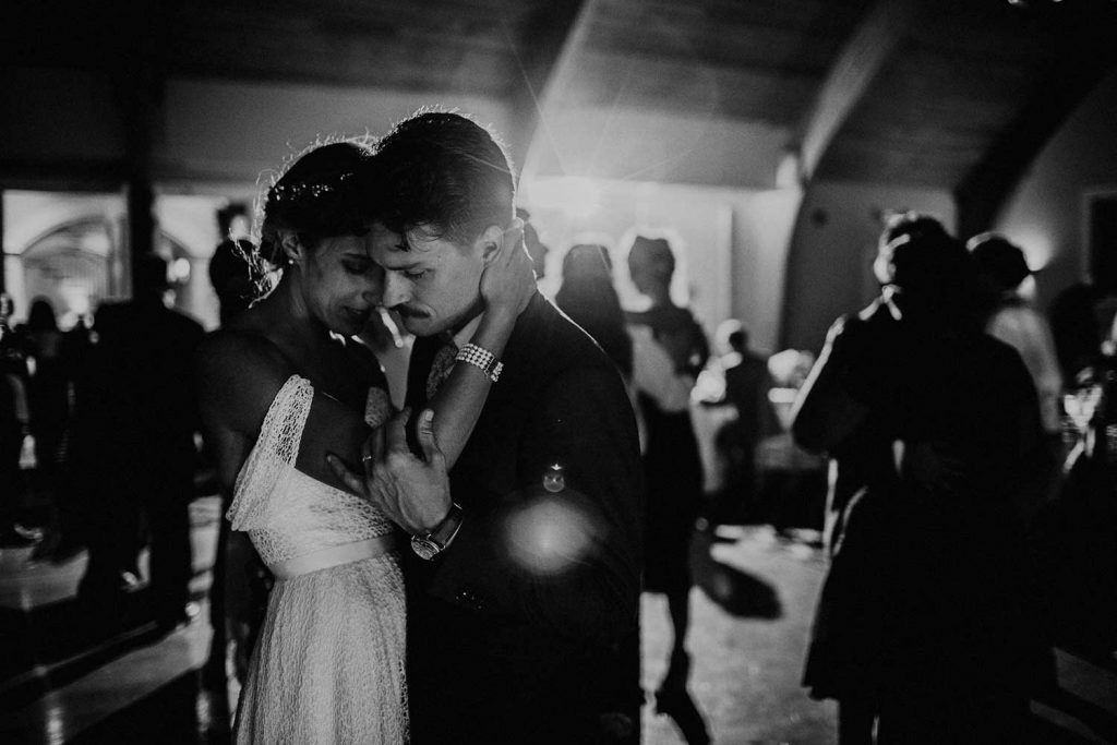 candid wedding photo of bride and groom dancing at reception