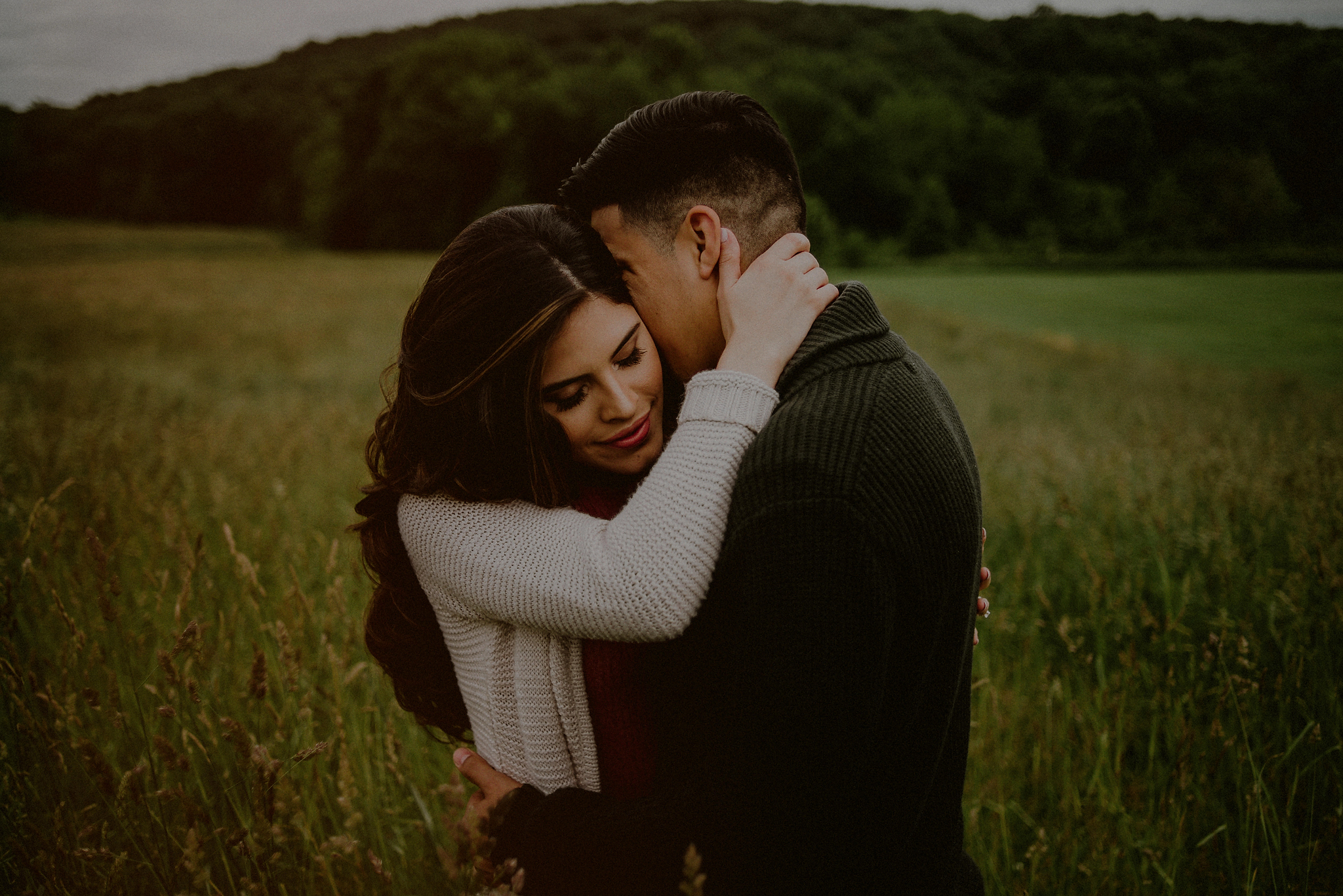 romantic engaged couple in field