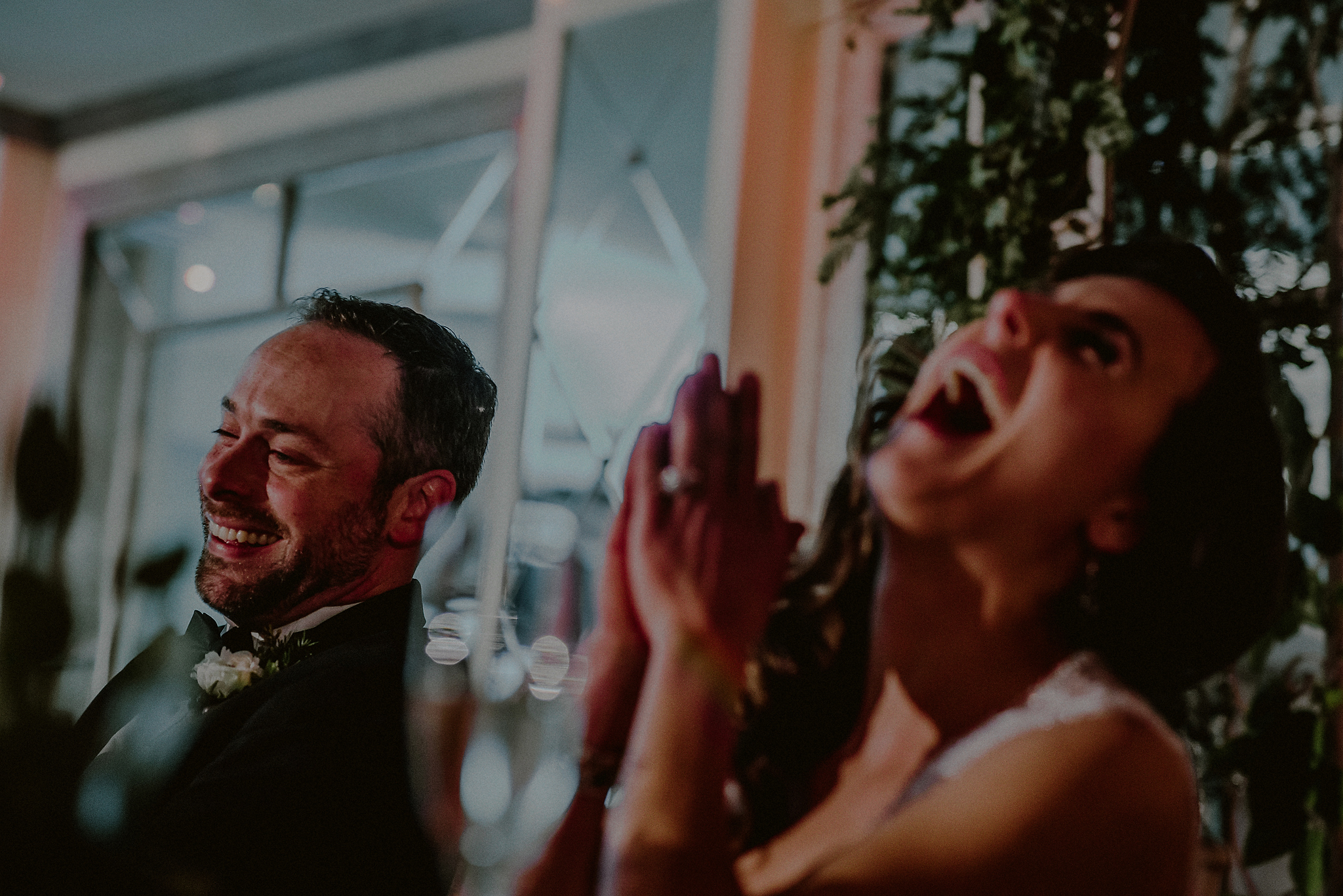 candid wedding photographs bride and groom reaction to toast