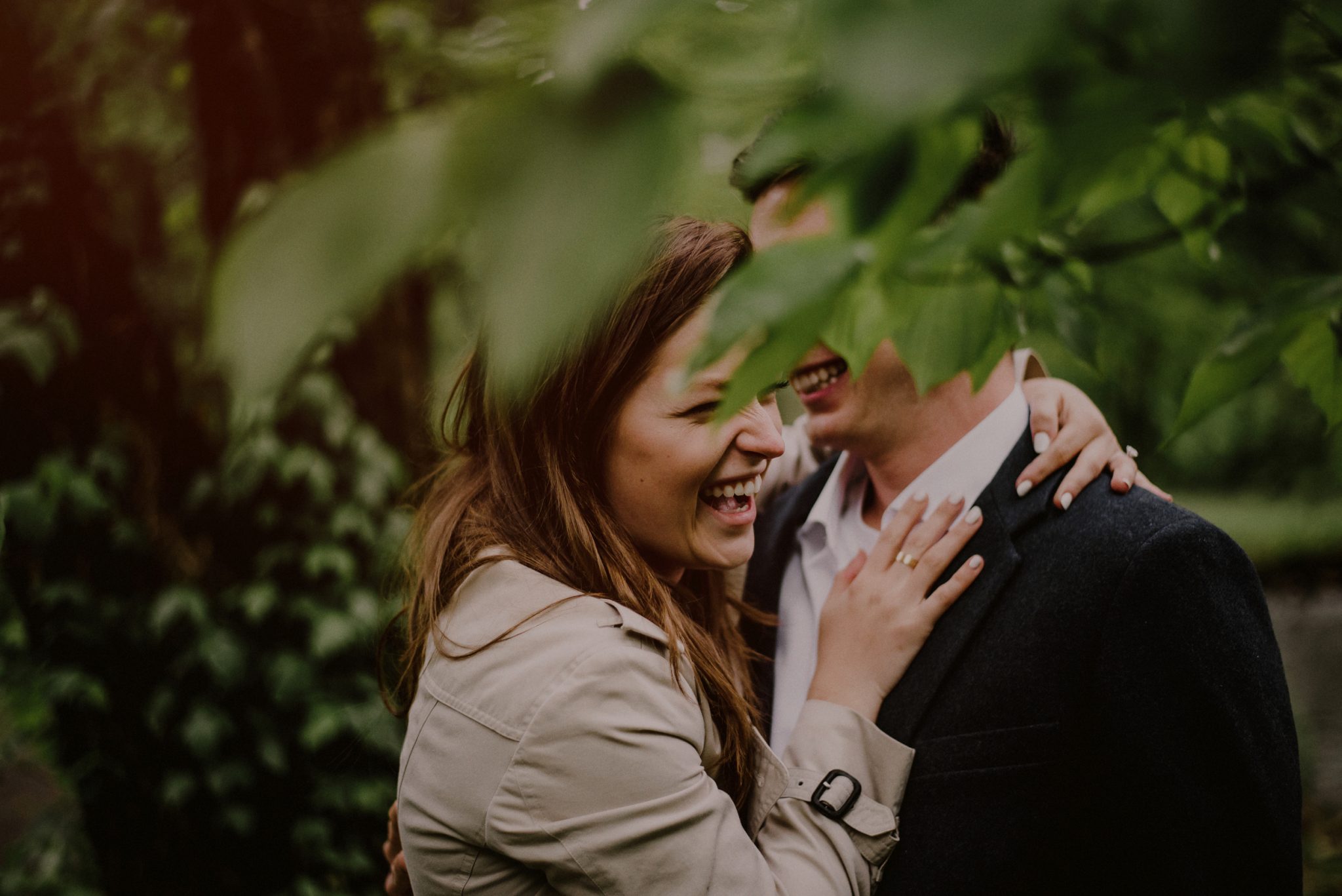 candid engagement photo of couple in woods at Natirar Park NJ