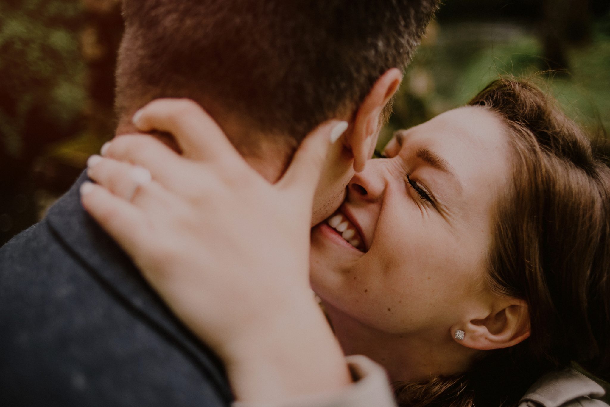 happy engaged couple kissing by engagement photographer Carolina Rivera