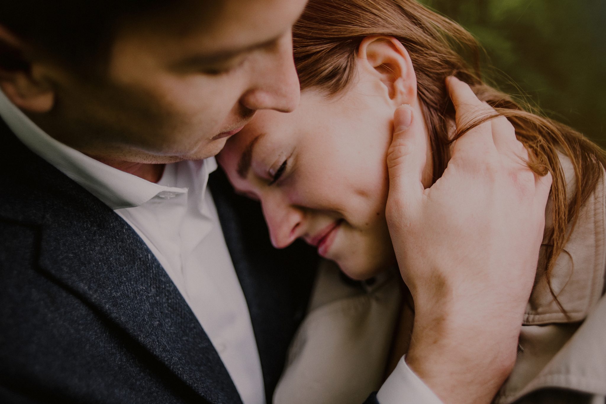 close up image of engaged couple embracing surprise proposal