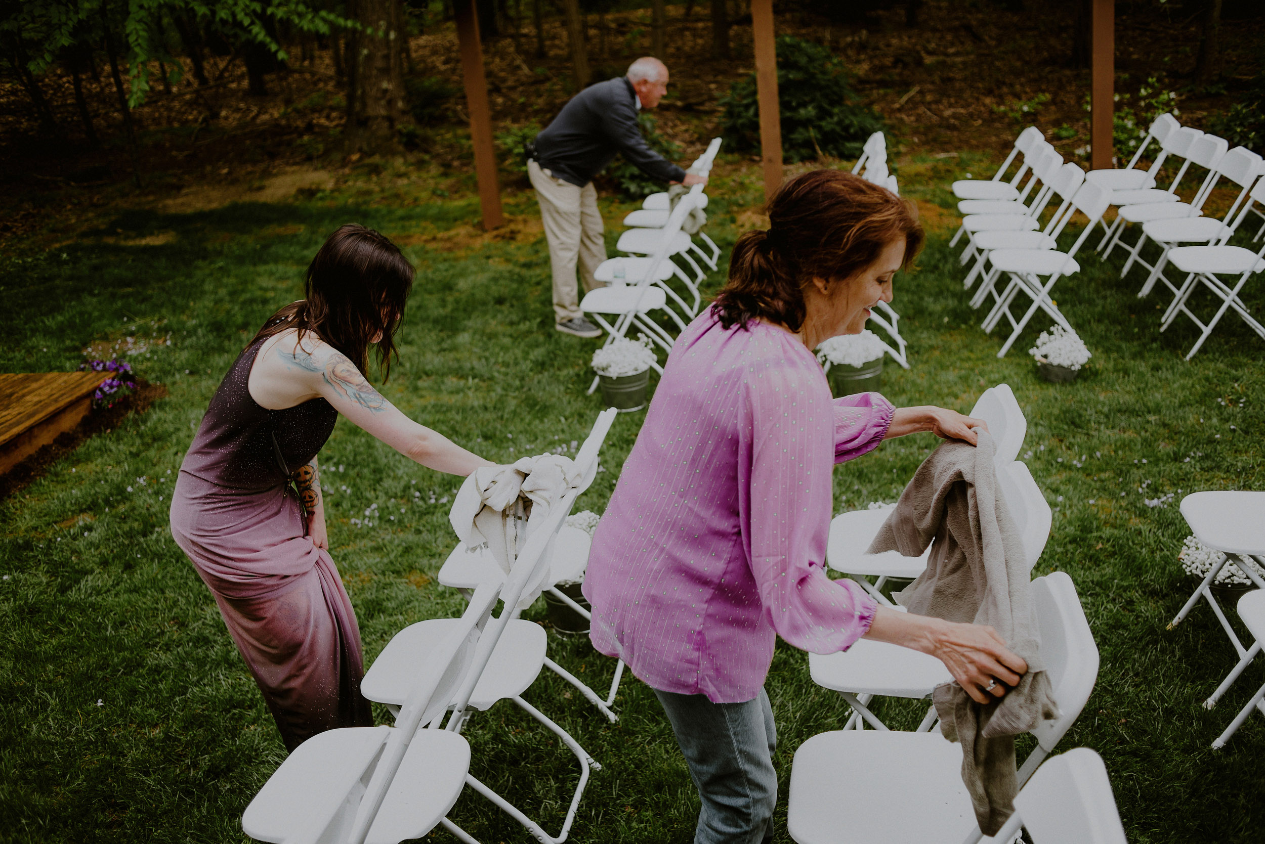 family helps set up diy backyard wedding