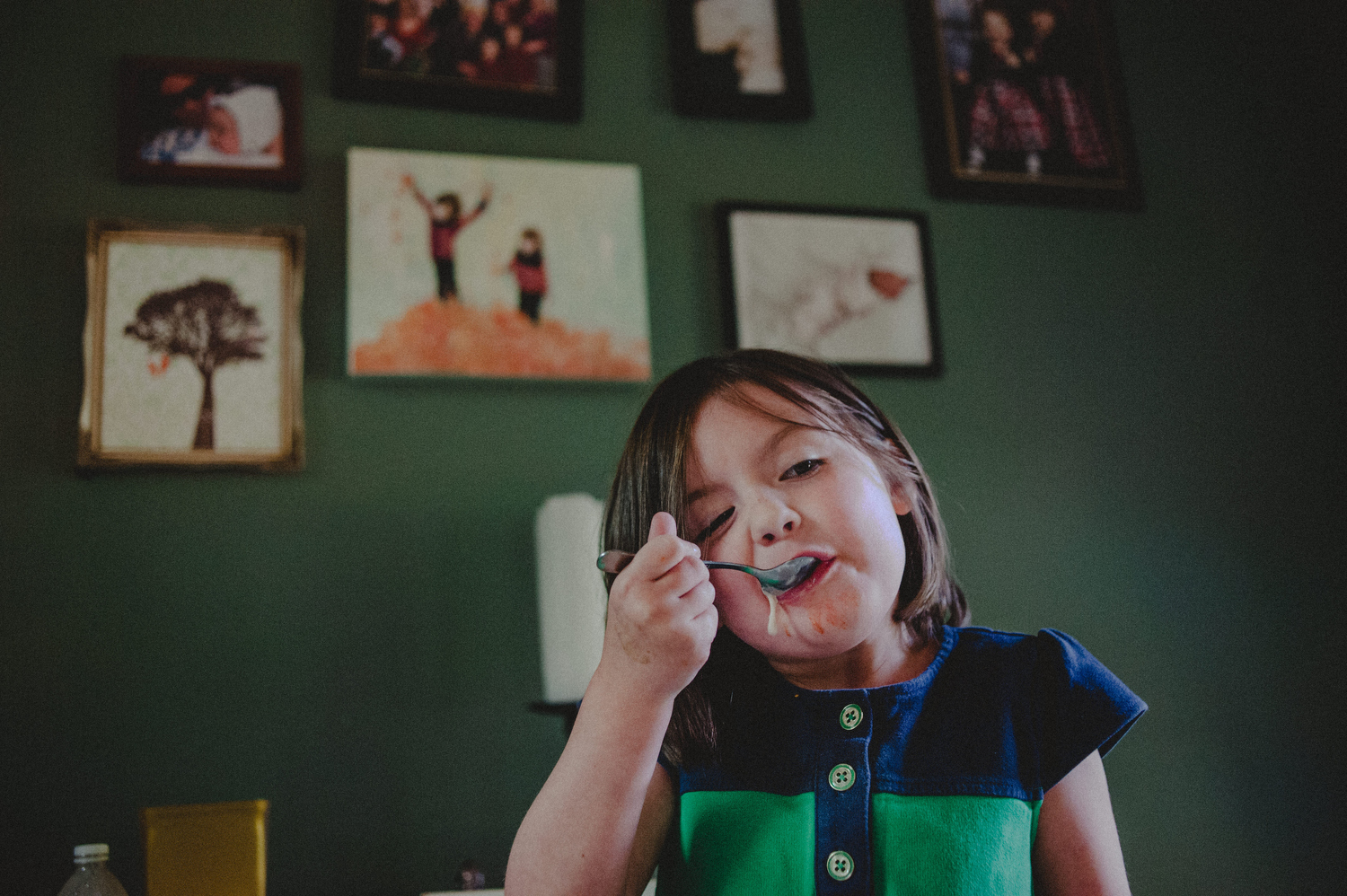 documentary photo of young girl eating ice cream dripping down cheek