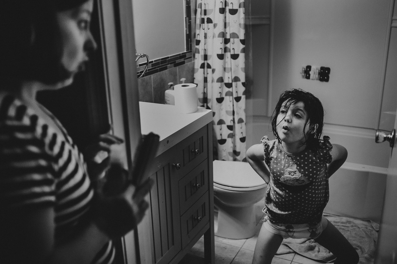 mother scolding daughter in bathroom as part of everyday moments from day in the life photography