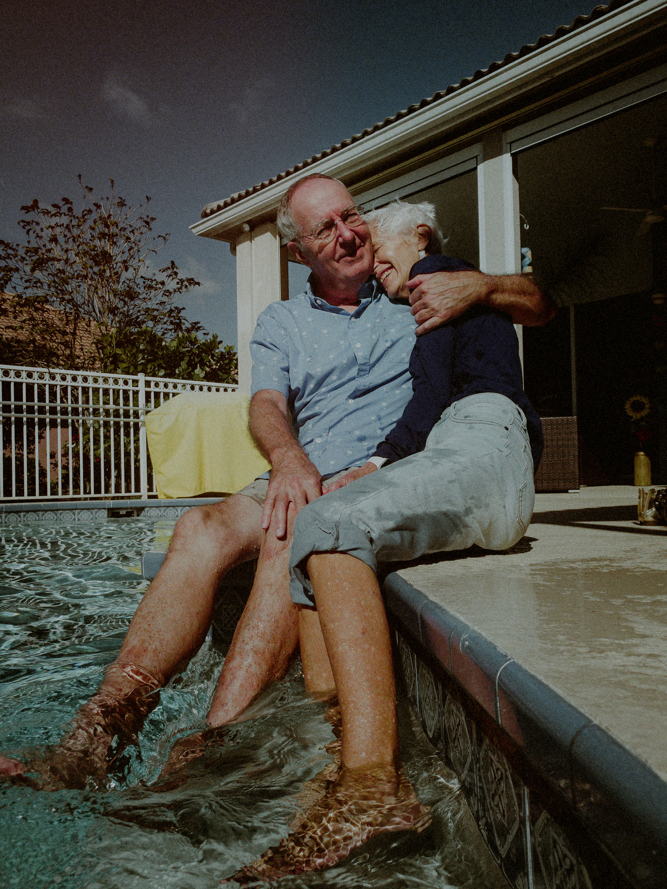 mature couple in florida pose poolside for facetime photo
