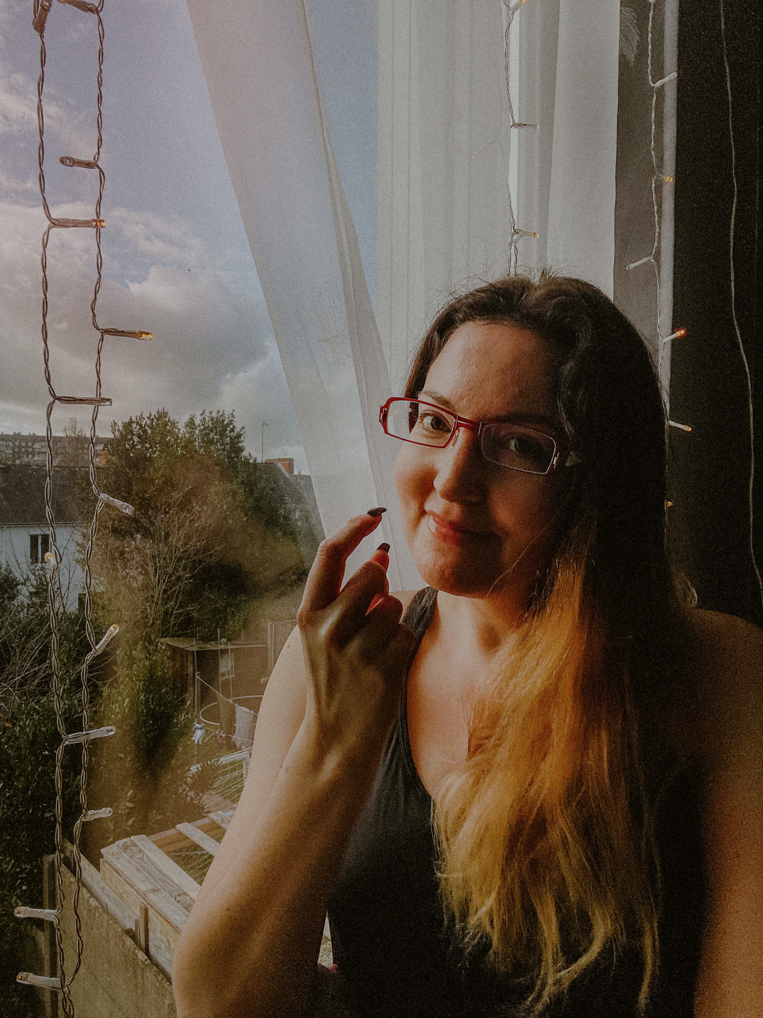 woman poses for virtual photo shoot on windowsill in france