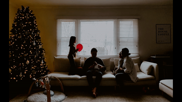 facetime photo of family on couch next to christmas tree