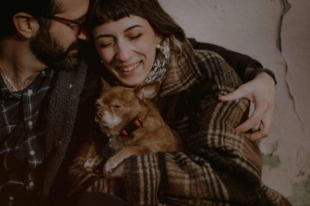 posing for engagement photos with dog