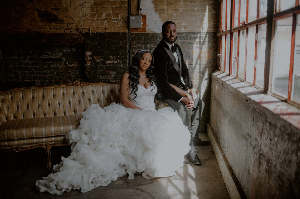 photo of wedding couple posing in a rustic industrial setting
