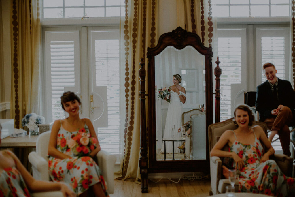 bride view in the mirror getting ready for wedding in suite at bonnet island estate, Long Beach, NJ