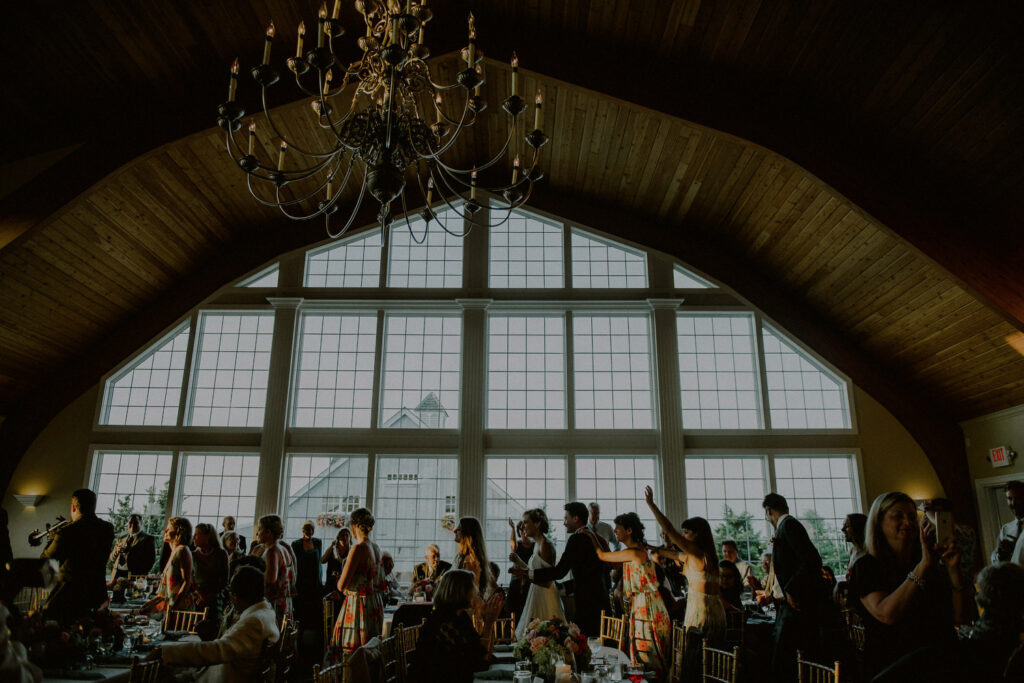 wedding guests enjoying reception at ballroom with floor-to-ceiling window at bonnet island estate