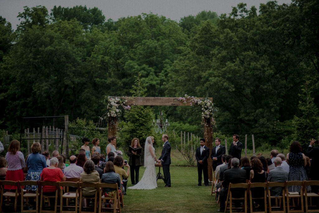 wedding ceremony under handmade arch at natirar 