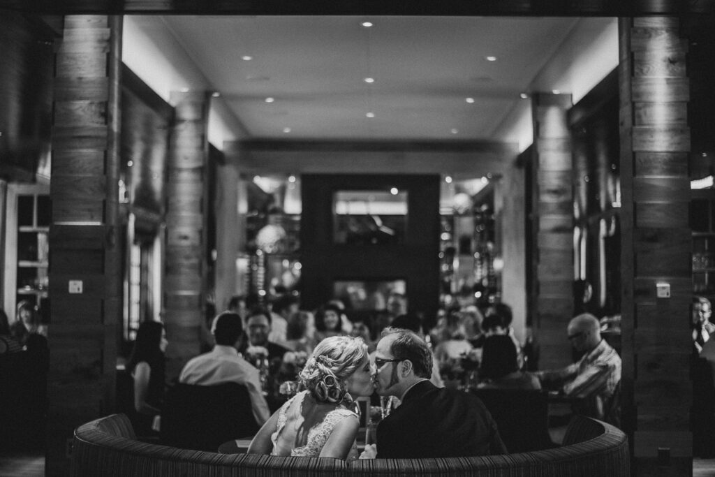 couple kissing at 90 acres restaurant wedding reception