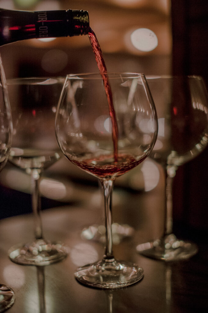 red wine pouring into glass 90 Acres Wedding Photos