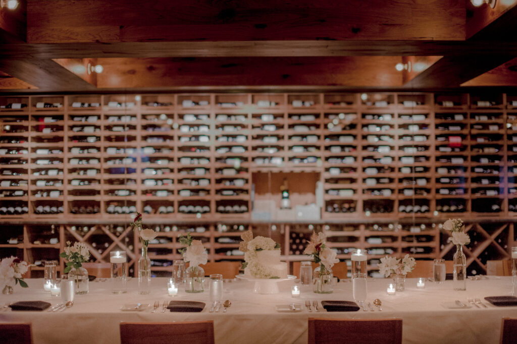 intimate candlelit table set up for an intimate wedding in the wine cellar of 90 acres restaurant