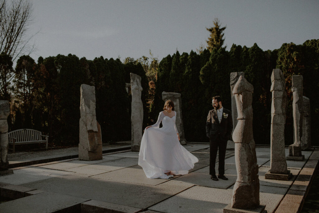 wedding portrait of couple amongst sculpture at the grounds for sculpture