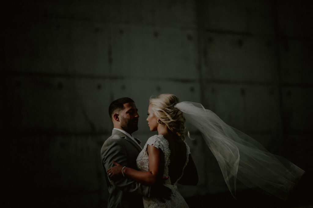 artistic bride and groom photo in front of mural at Liberty State Park in Jersey City NJ