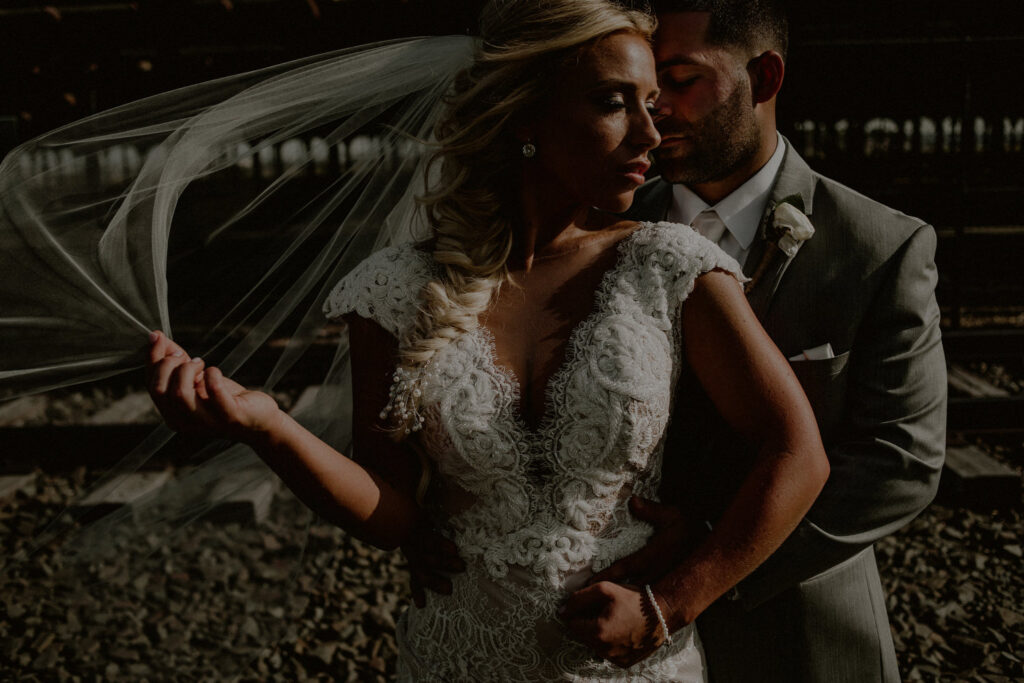 dramatic photo of wedding couple in an editorial style pose with moody dramatic editing style