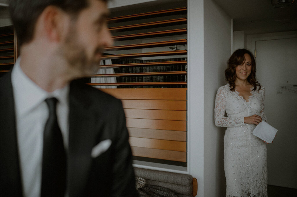 wedding couple getting ready together and looking at each other lovingly