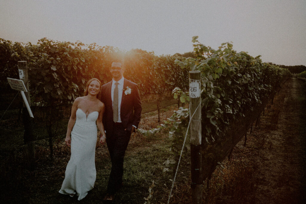 candid wedding portrait during sunset of couple in a vineyard 