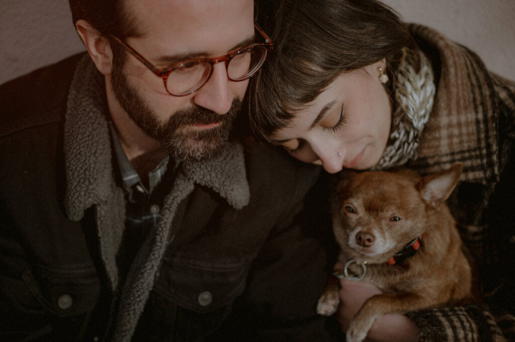 couple cuddling with chihuahua