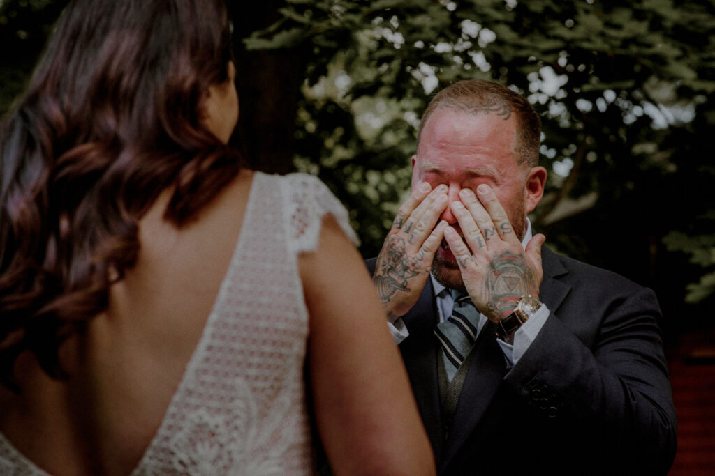 photo of groom crying during wedding ceremony