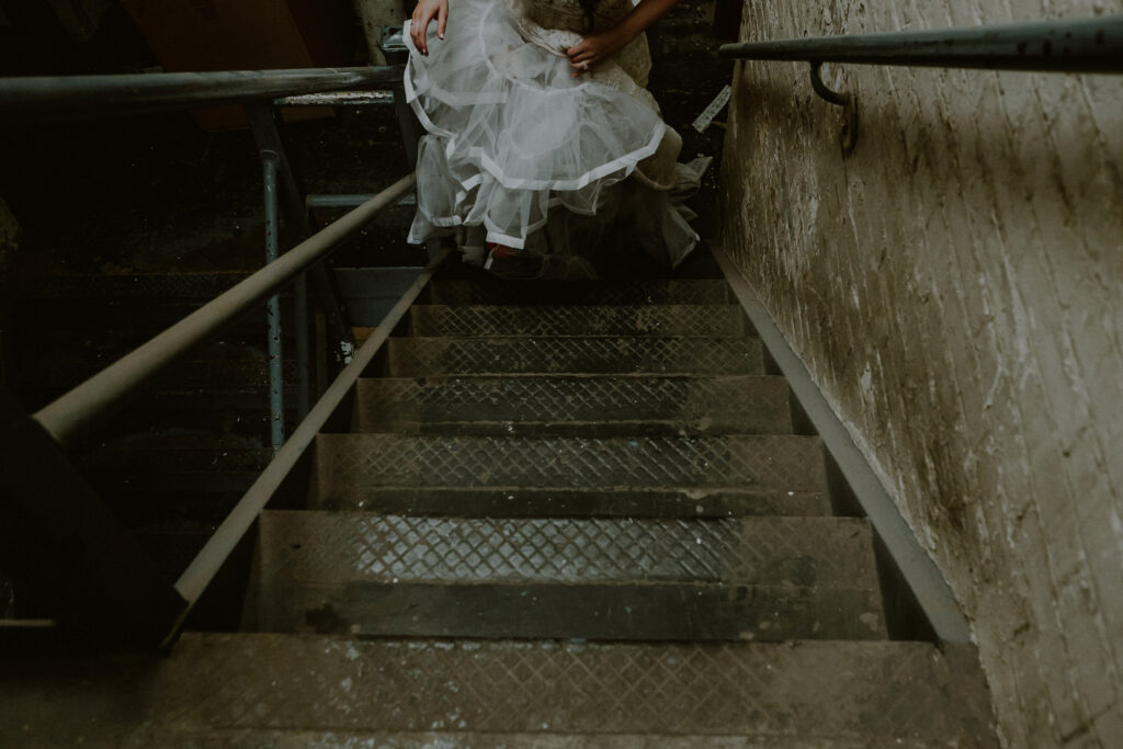 bride walking up industrial steps