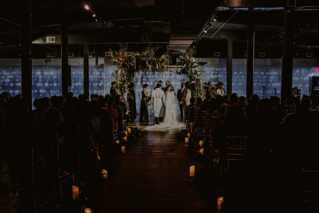 jewish wedding ceremony at factory 220 with bride and groom in front of chuppah