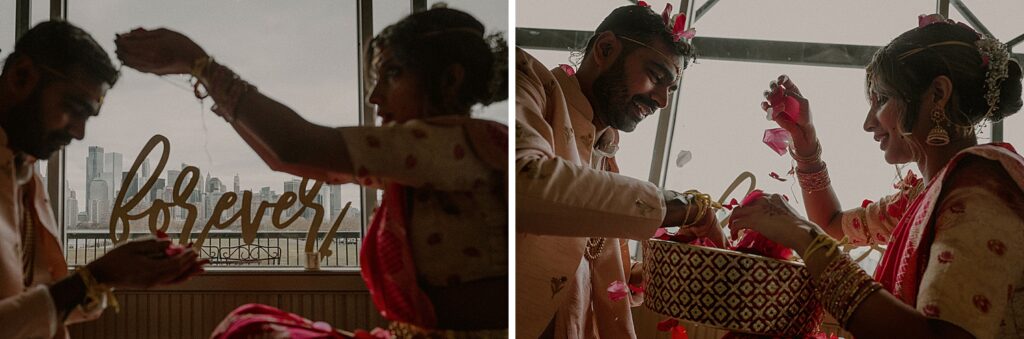 bride and groom facing each other and pouring rose petals on each other while overlooking the nyc skyline