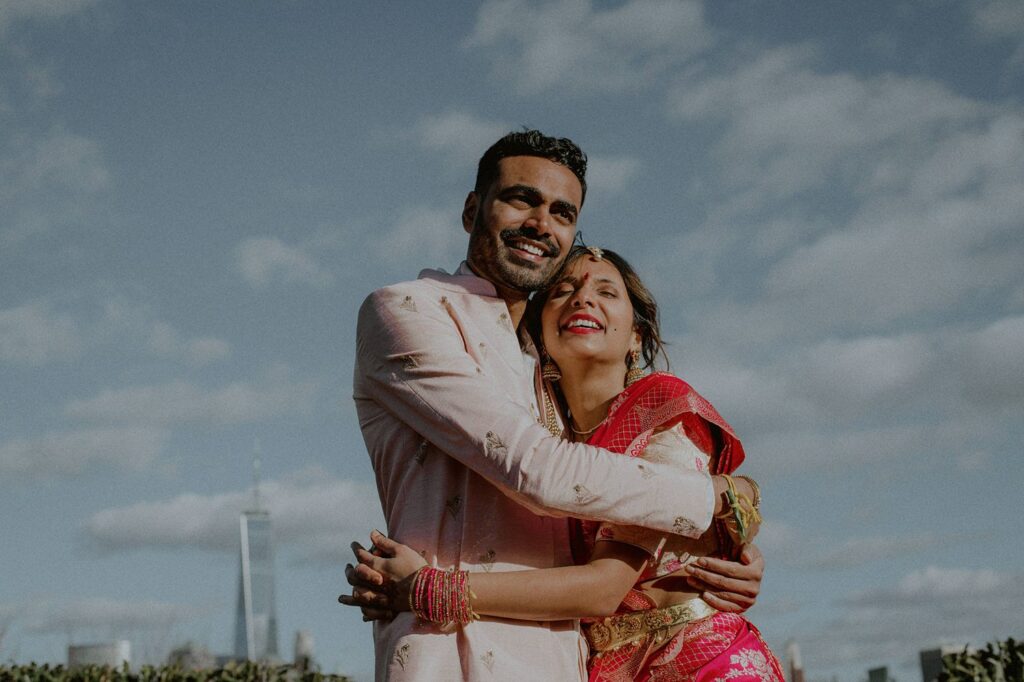 bride and groom hugging each other and enjoying a candid moment while laughing