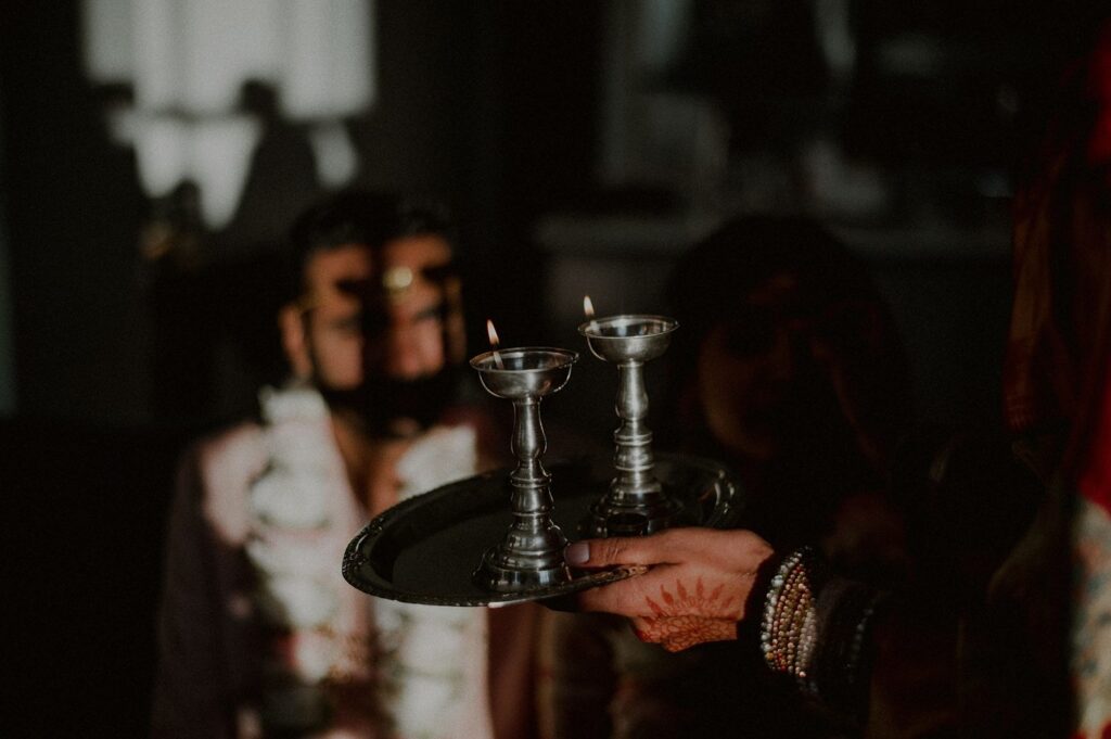 creative photo of candles in front of bride and groom in background