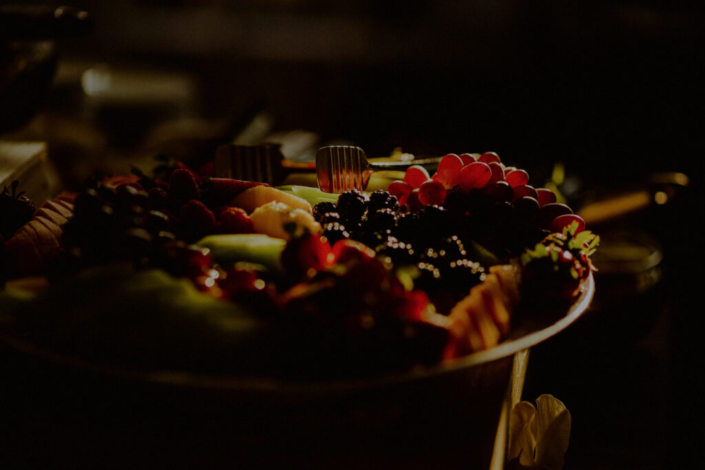 fruit and cheese plate at cocktail hour in moody sunlight