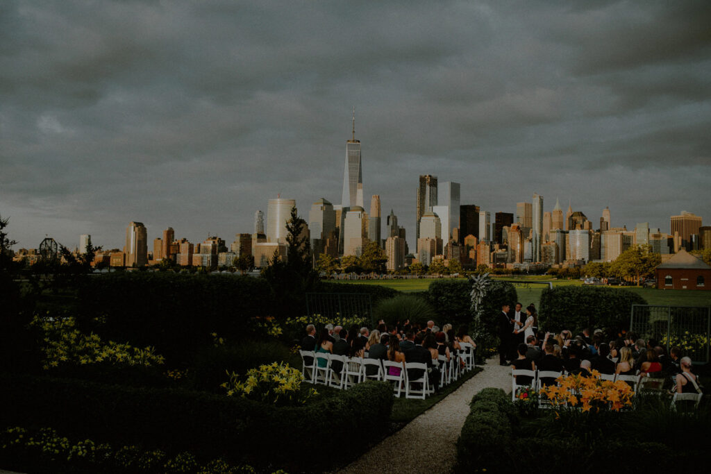 picturesque outdoor wedding ceremony at sunset with stunning view of nyc skyline