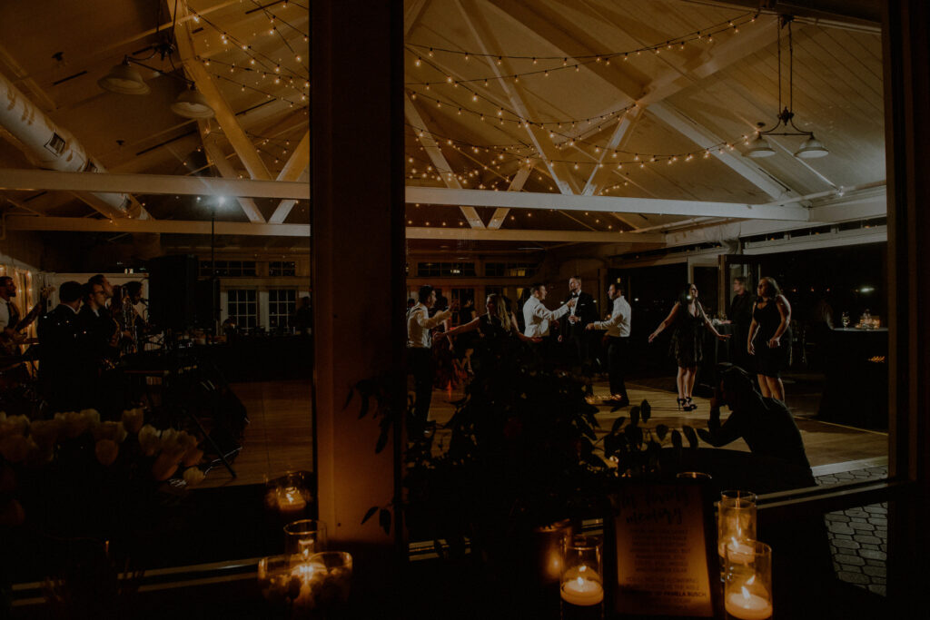 evening wedding reception at liberty house restaurant with slanted wooden ceilings and string lights