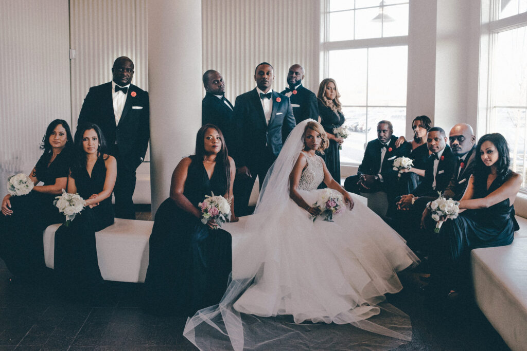 sleek black and white dressed bridal party in elegant bridal party photo at maritime parc lobby
