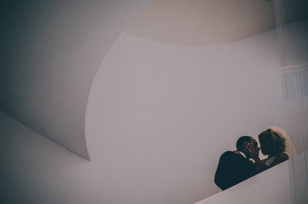 creative silhouette photo of bride and groom on modern staircase