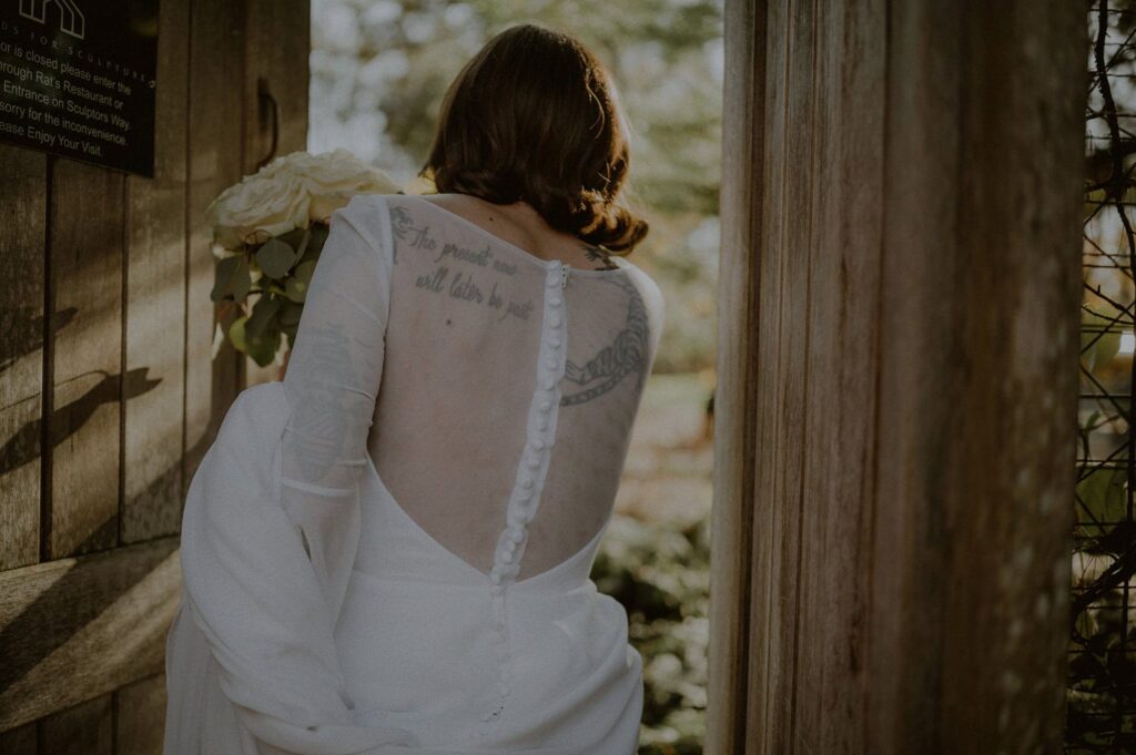 bride walking through a gate with back facing camera