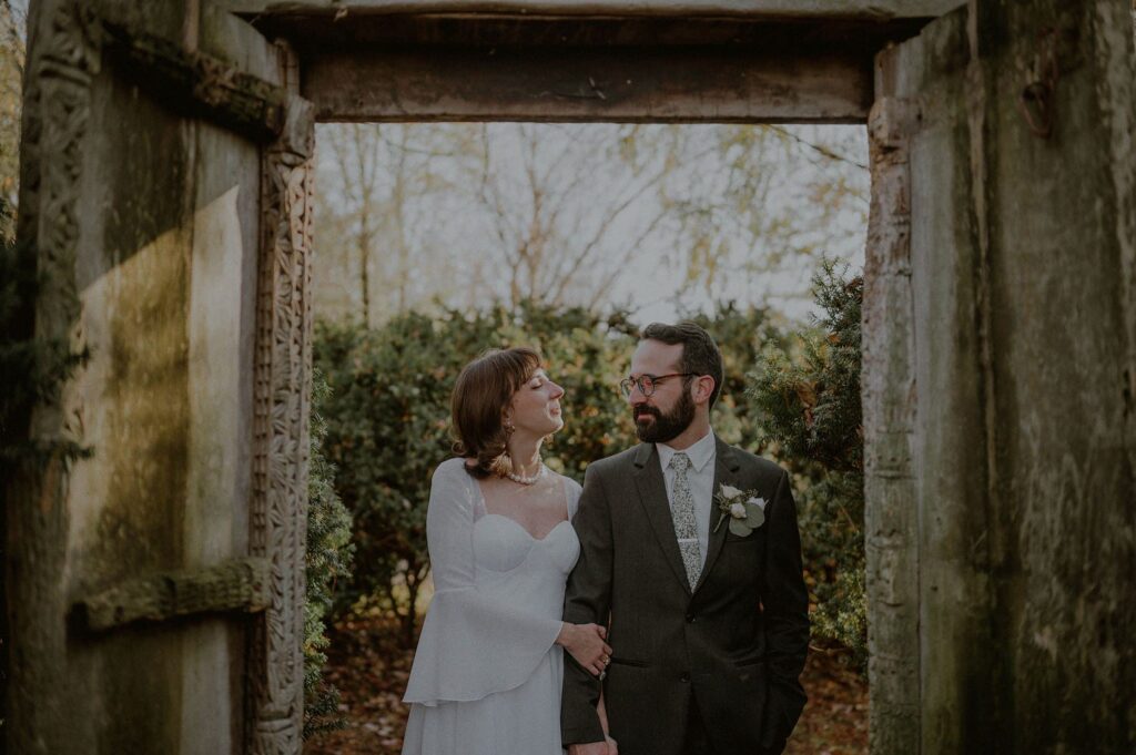 bride and groom posed portrait framed by doorway