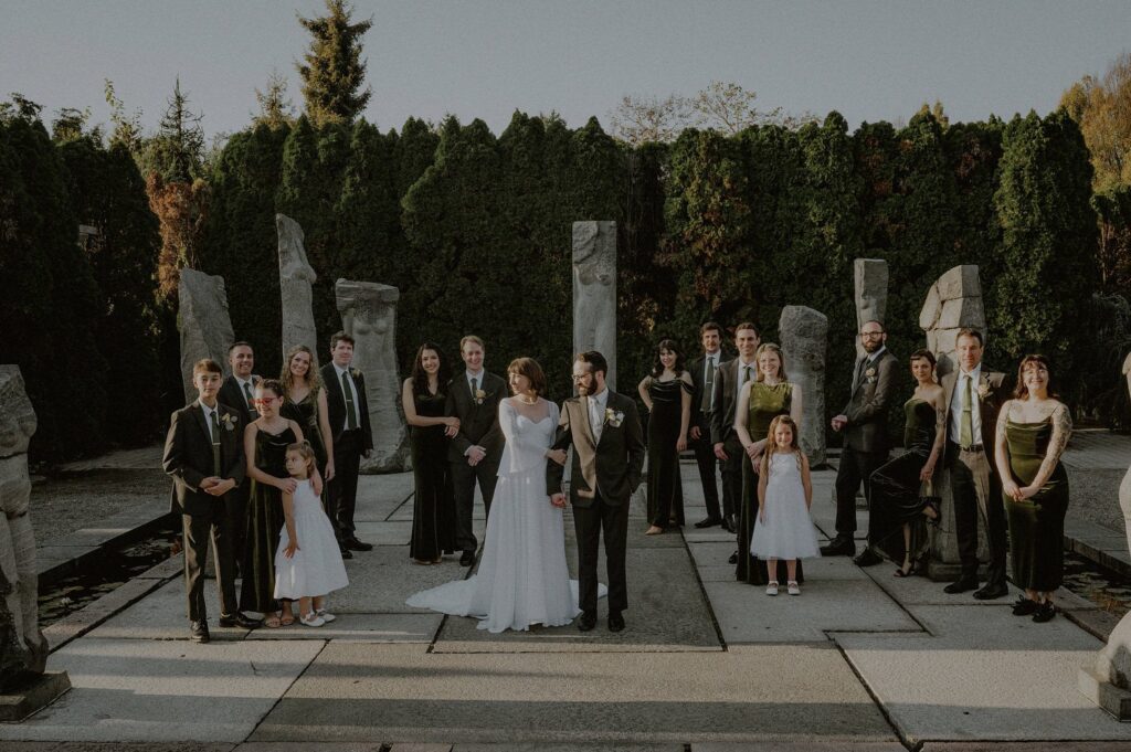 bridal party posed at grounds for sculpture nine muses