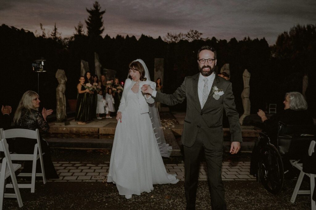 bride and groom exit ceremony space of nine muses at dusk