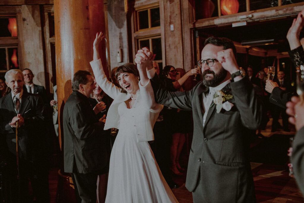 bride and groom joyfully entering reception